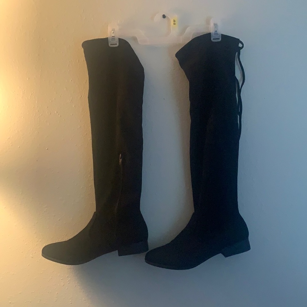Black knee-high boots. Worn once, in good condition. Has strings to tighten it